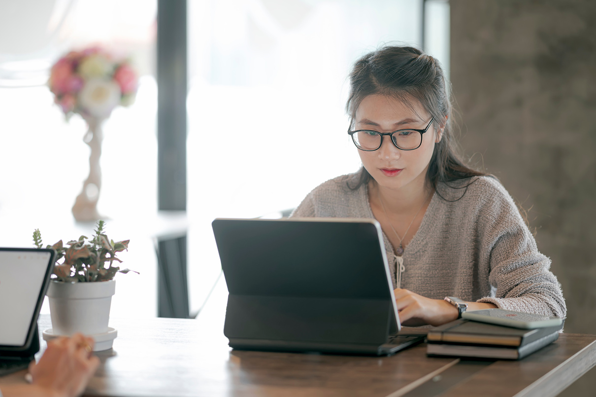 Asian Woman Student Using Computer for Online Learning.